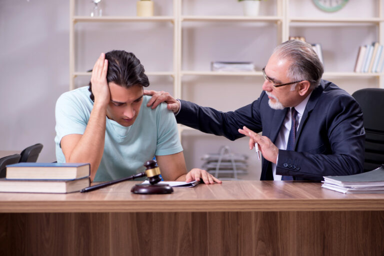 An aggravated assault attorney comforting his client in El Paso.